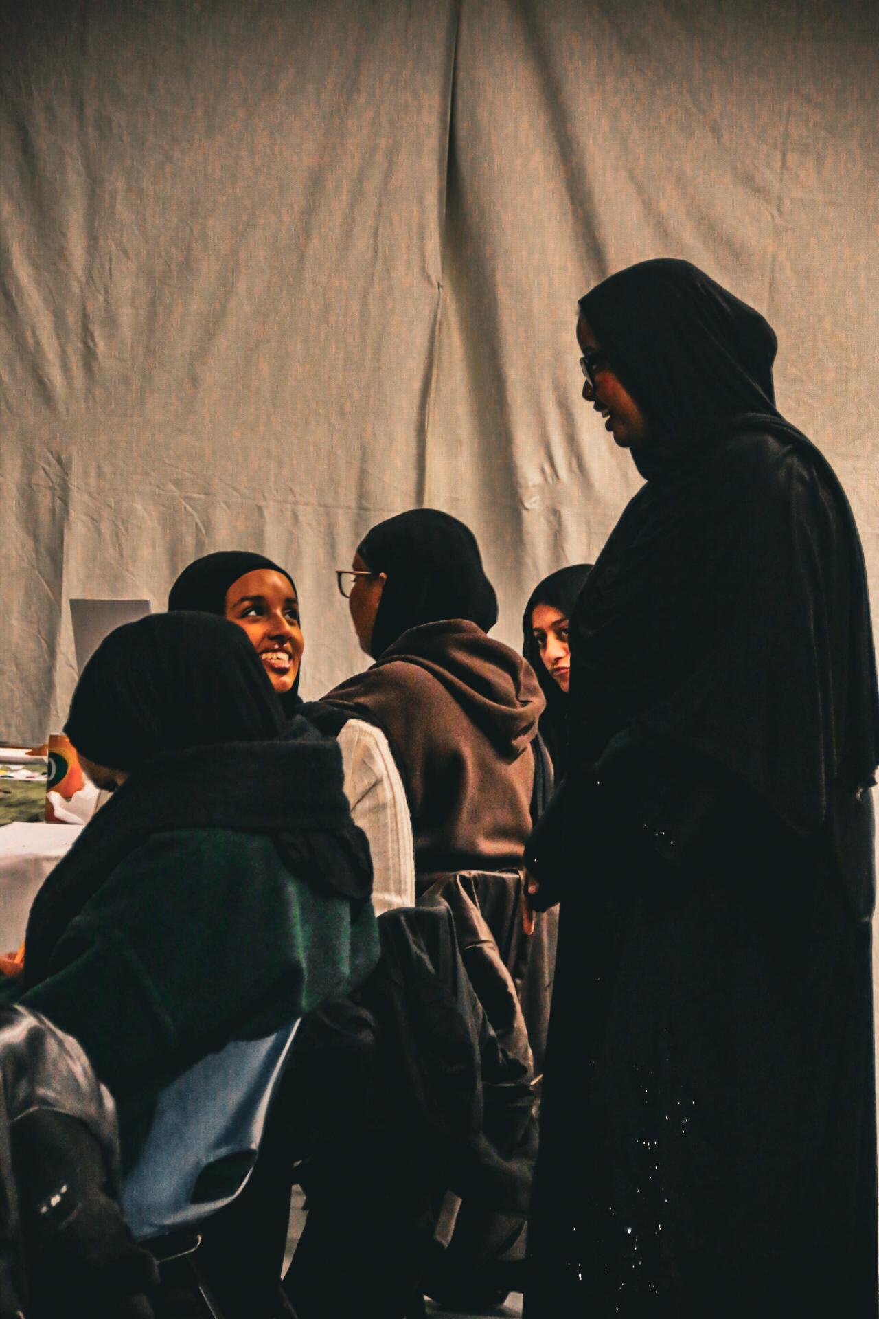 Women talking and smiling together at a Flow Café gathering